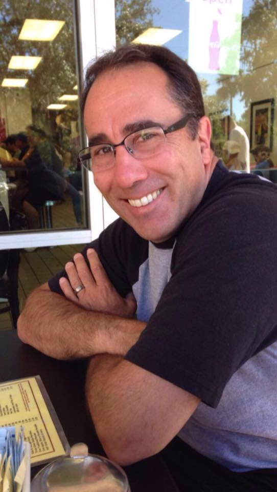 Rob with glasses smiling in a casual setting